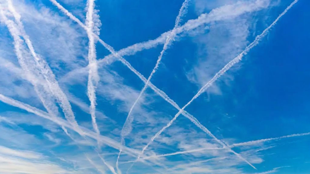 Intersecting Contrails Forming Crisscross Pattern in Blue Sky