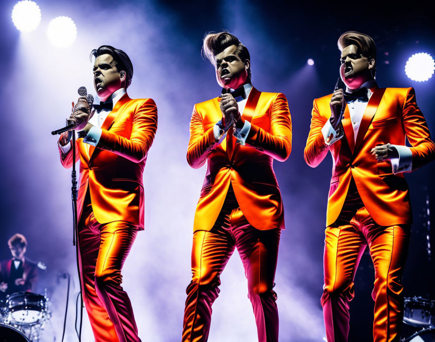 Vibrant Orange Suits Singers with Drummer on Stage