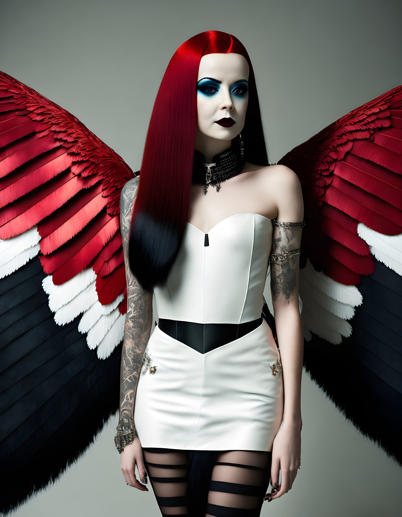 Stylized woman with red and black hair, wings, tattoos, and unique outfit