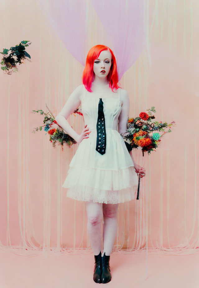 Red-haired woman in white dress with bouquet and tie on pink background