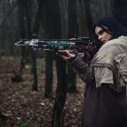 Surreal portrait of woman with mechanical bow headpiece in dark flora