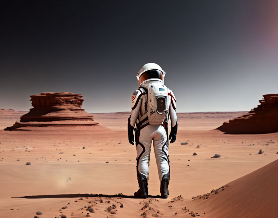 Astronaut in white space suit on barren, Mars-like landscape