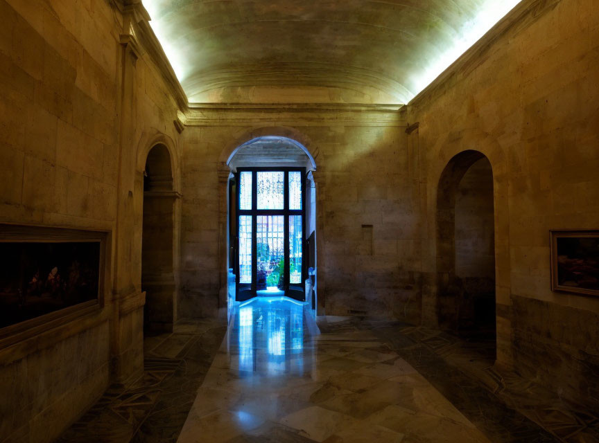 Historic building interior: vaulted ceiling, stone floor, artwork, open door