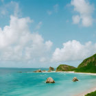 Tranquil Beach Scene with Turquoise Waters and Rocky Shoreline