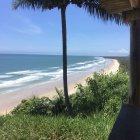 Colorful Beach View with Foliage Frame and Blue Skies