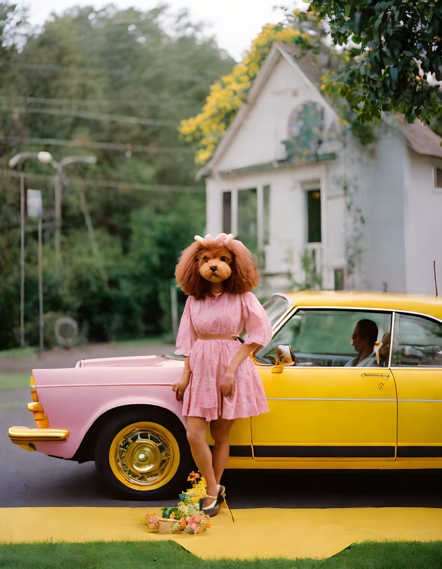 Person in Lion Head Mask and Pink Dress by Vintage Car and House with Trees