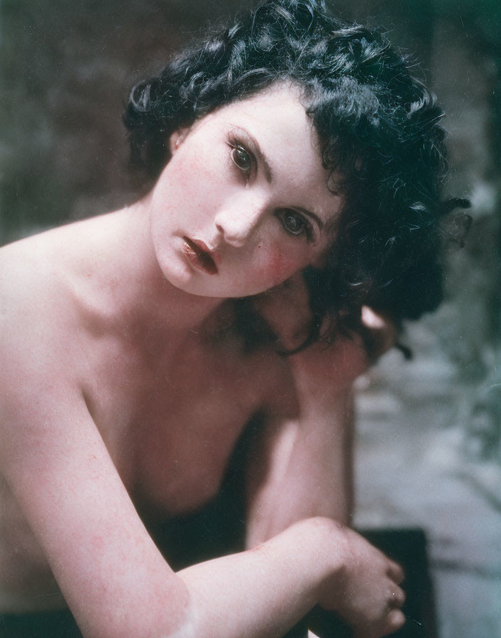 Vintage portrait of woman with dark curly hair and bare shoulders, early to mid-20th century