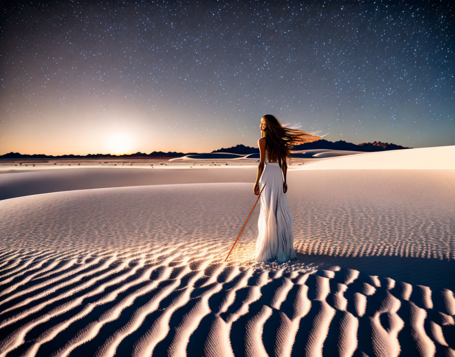 Woman in white dress on sand dune under starry sky with windswept hair and staff.