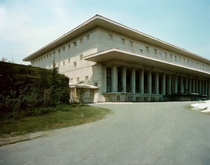 Classical building with columns by curved road