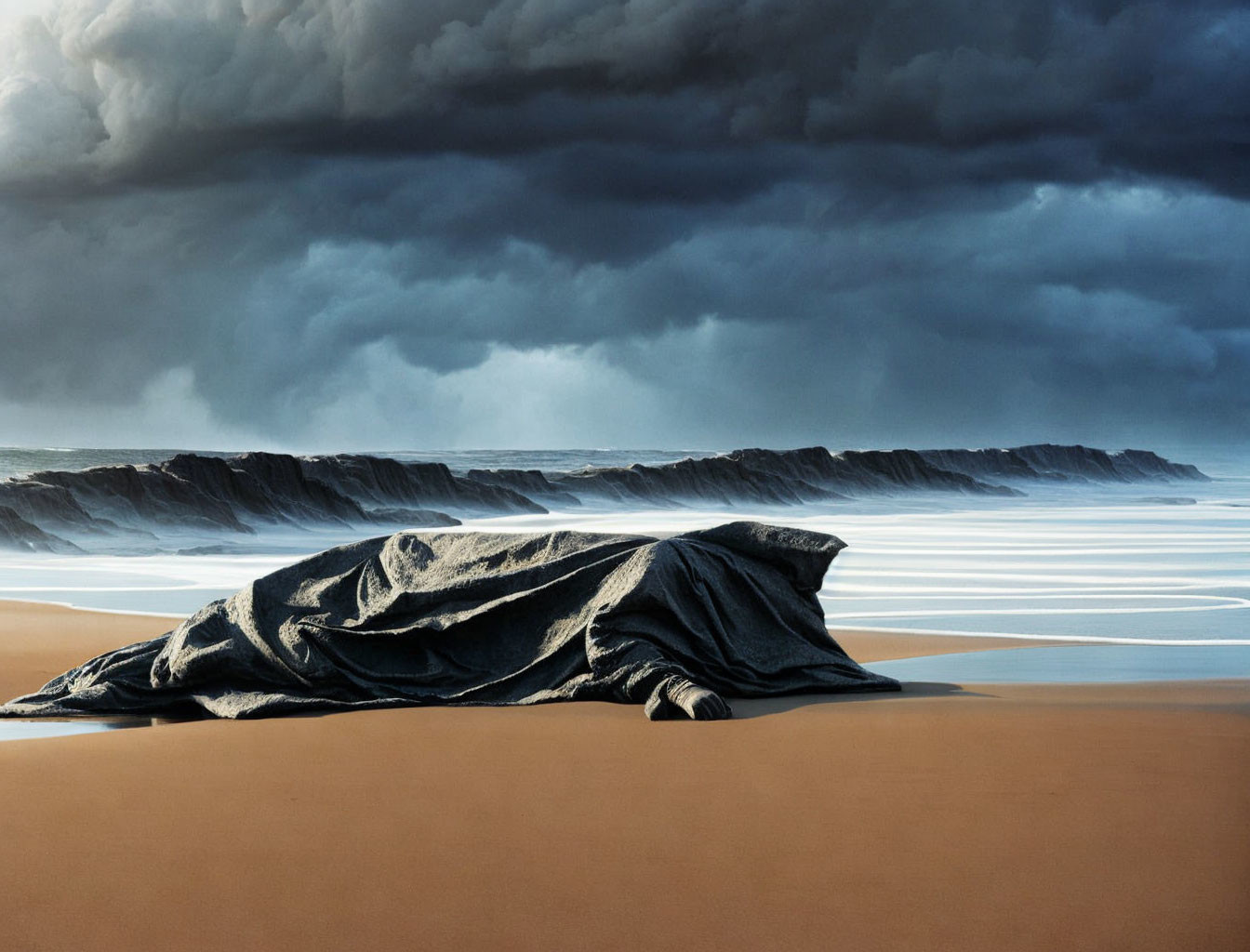 Draped structure on sandy beach under stormy sky