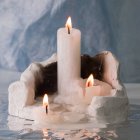 Candles on Spiral Stand with Golden Sparkles and Water Reflections