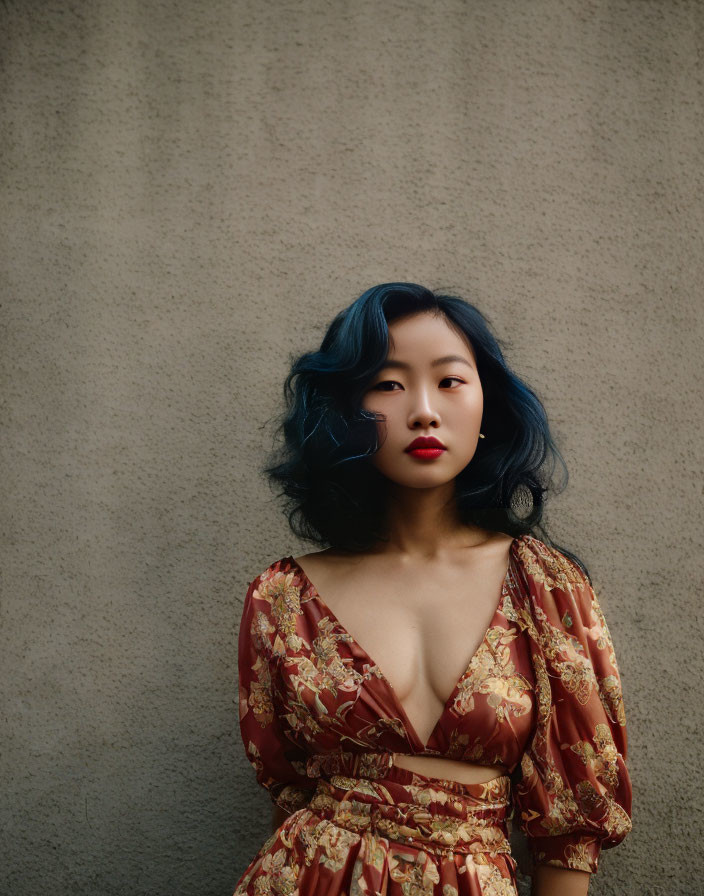 Woman with Blue Hair and Red Lipstick in Floral Dress on Gray Background