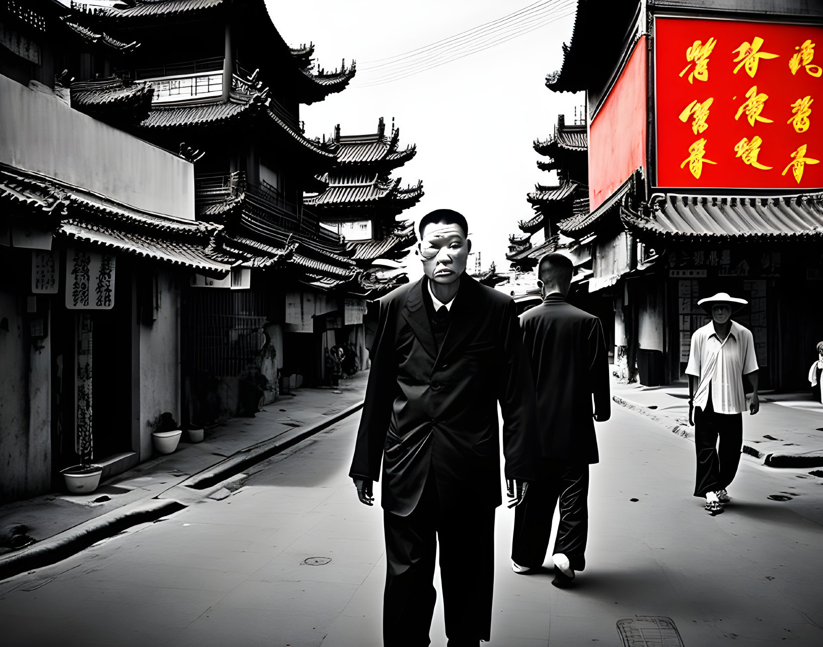 Man in dark suit walking down old street with traditional Chinese architecture and red Chinese characters sign.