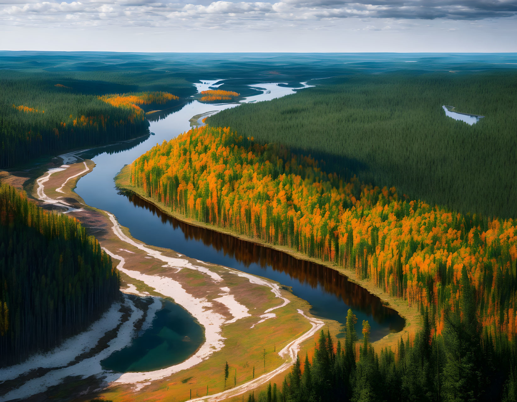 Winding River Through Autumn Forest with Road