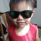 Colorful Child Portrait with Sunglasses and Flower Shirt on Blurred Background