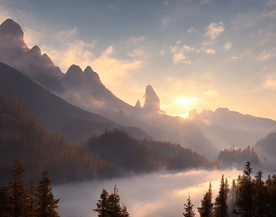 Misty mountainous landscape at sunset with sunlight piercing through valleys