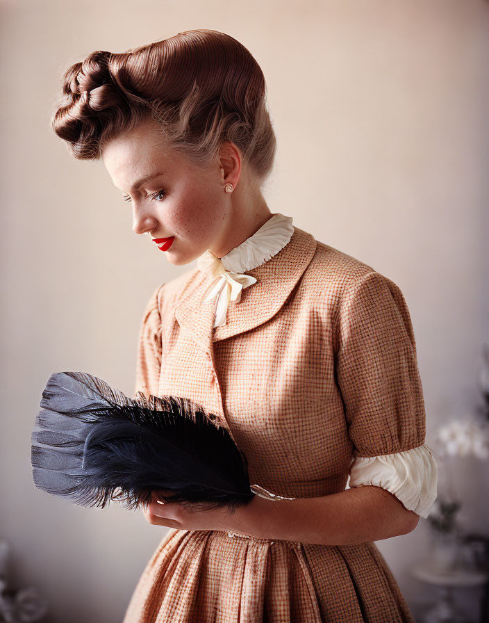 Vintage woman in checkered dress with feather fan and updo hairstyle