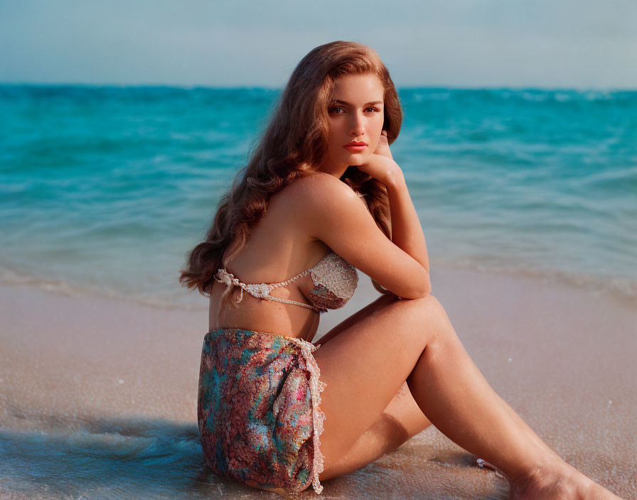 Woman in bikini on sandy beach with ocean view