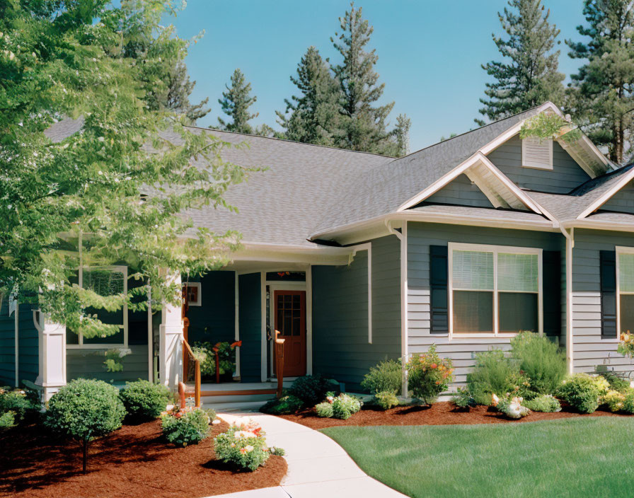 Blue Siding Single-Story Home with Front Porch and Landscaped Garden