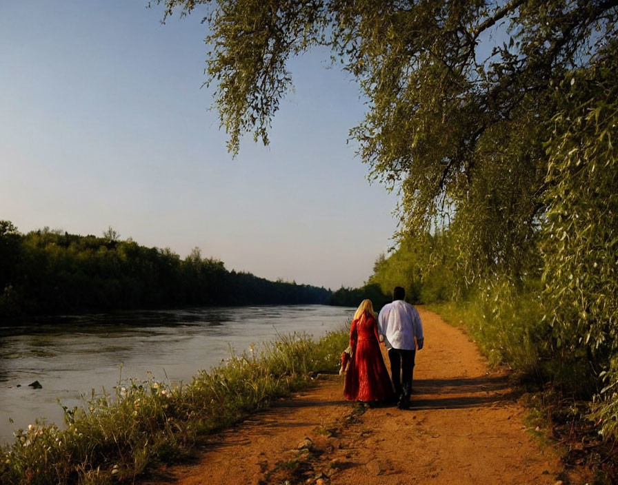 Couple Walking Hand in Hand by Serene Riverside at Sunset