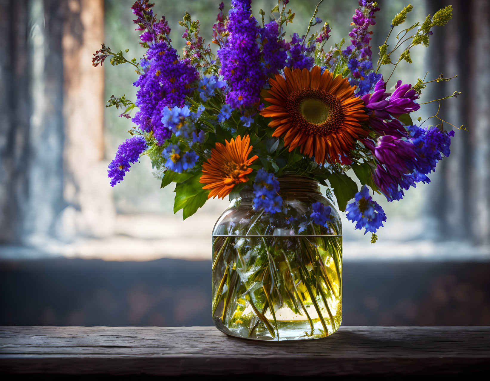 Colorful Sunflower and Purple Flower Bouquet in Glass Jar on Wooden Surface