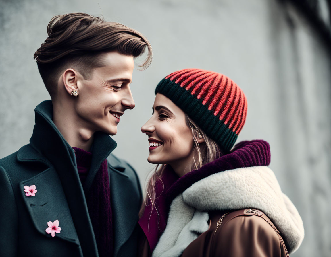 Young couple in winter attire sharing joyful moment