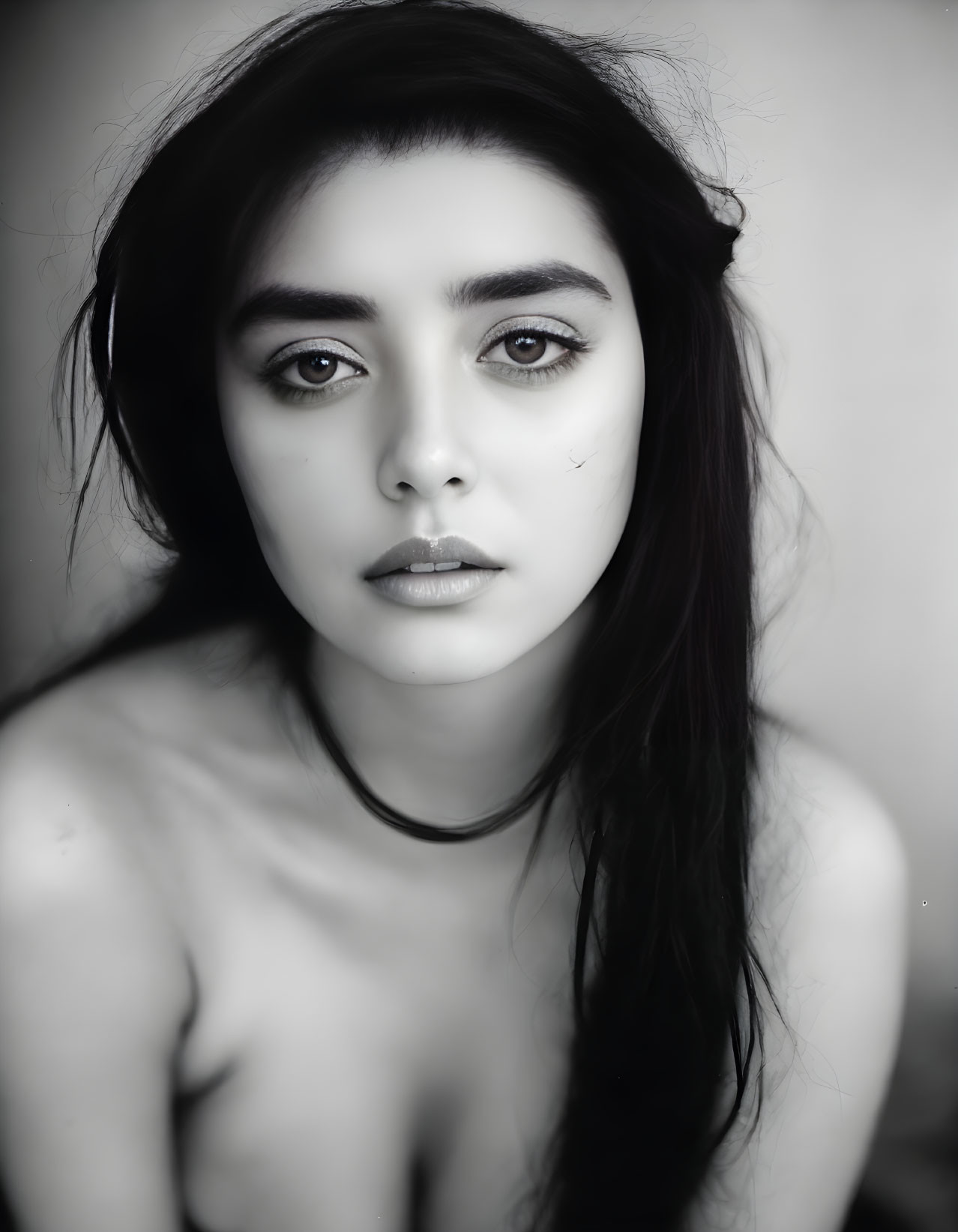 Monochrome portrait of a young woman with dark hair and fair skin