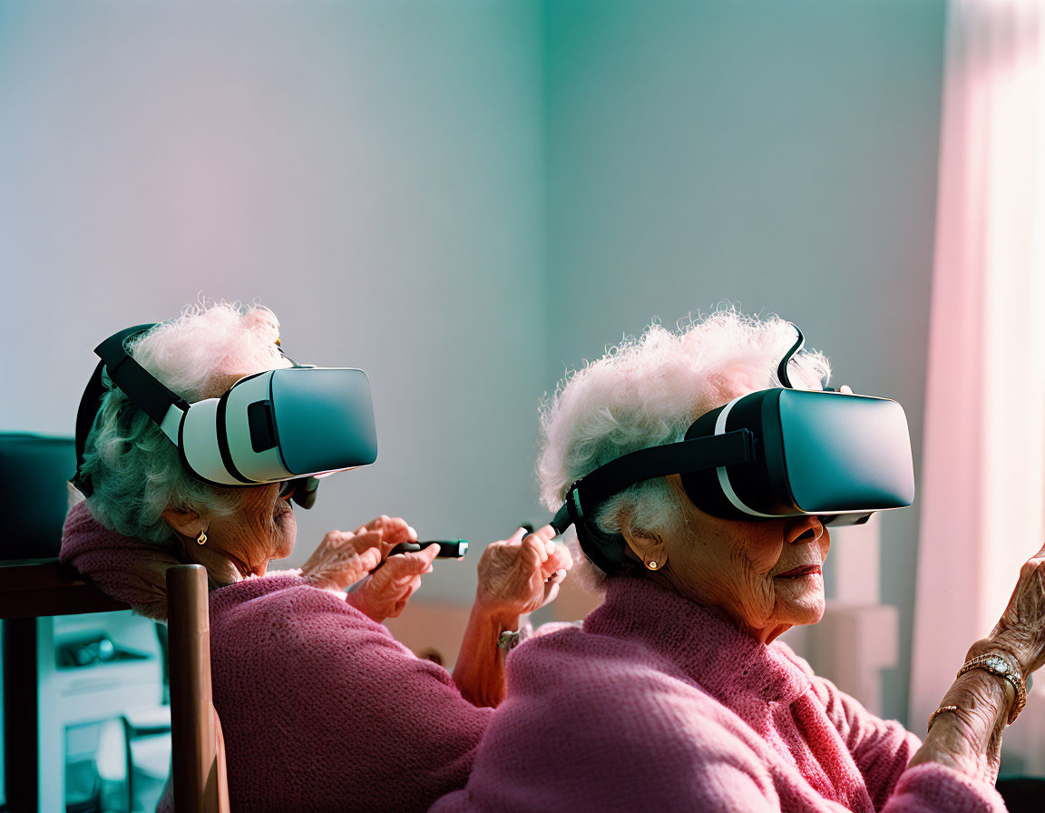 Elderly women in VR headsets with controller in softly lit room