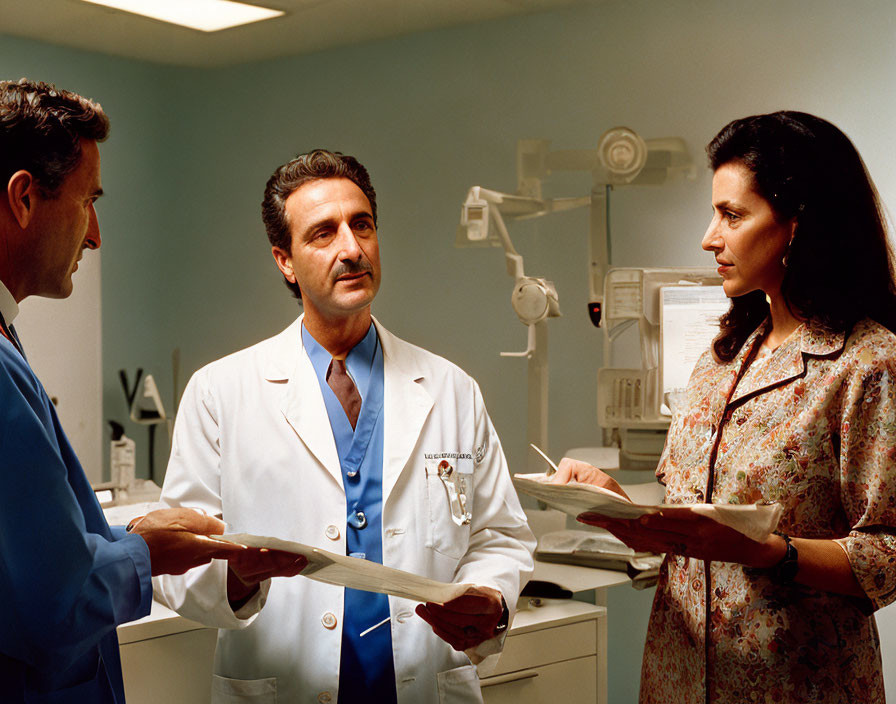 Healthcare professionals in hospital room discussing documents