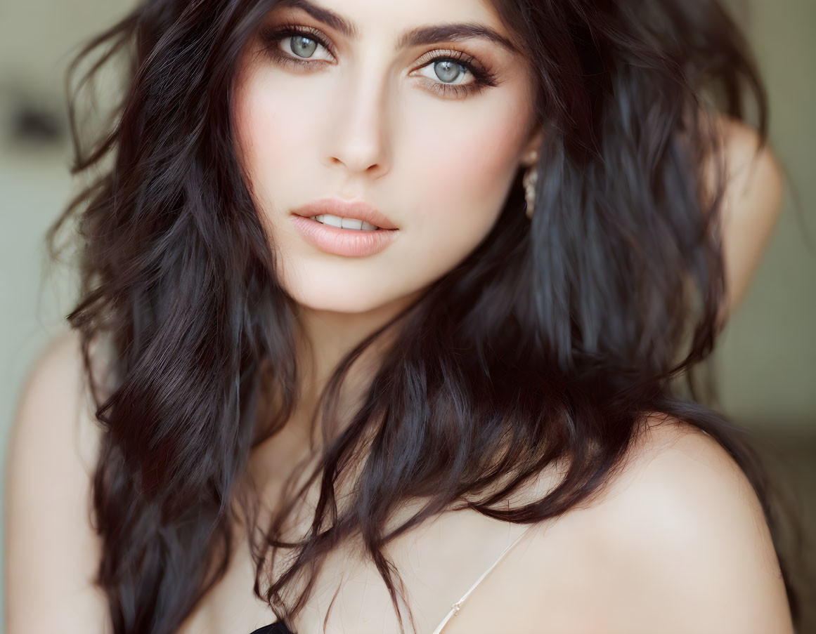 Portrait of Woman with Dark Wavy Hair and Green Eyes