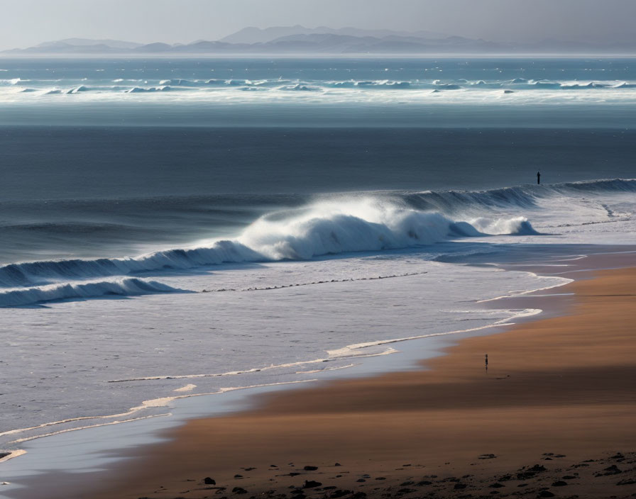 Figure on Beach with Waves, Mountains, and Hazy Sky