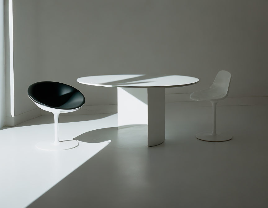 Bright minimalist room with white round table and contrasting chairs