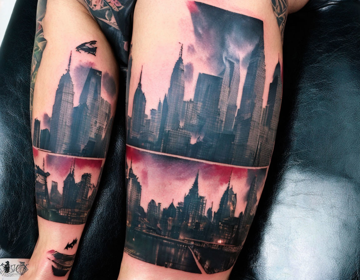 Detailed cityscape tattoo with skyscrapers and bats on two arms