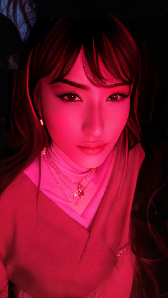 Portrait of woman in pink turtleneck under vivid pink light