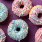 Vibrant Sprinkle Donuts on Purple Background