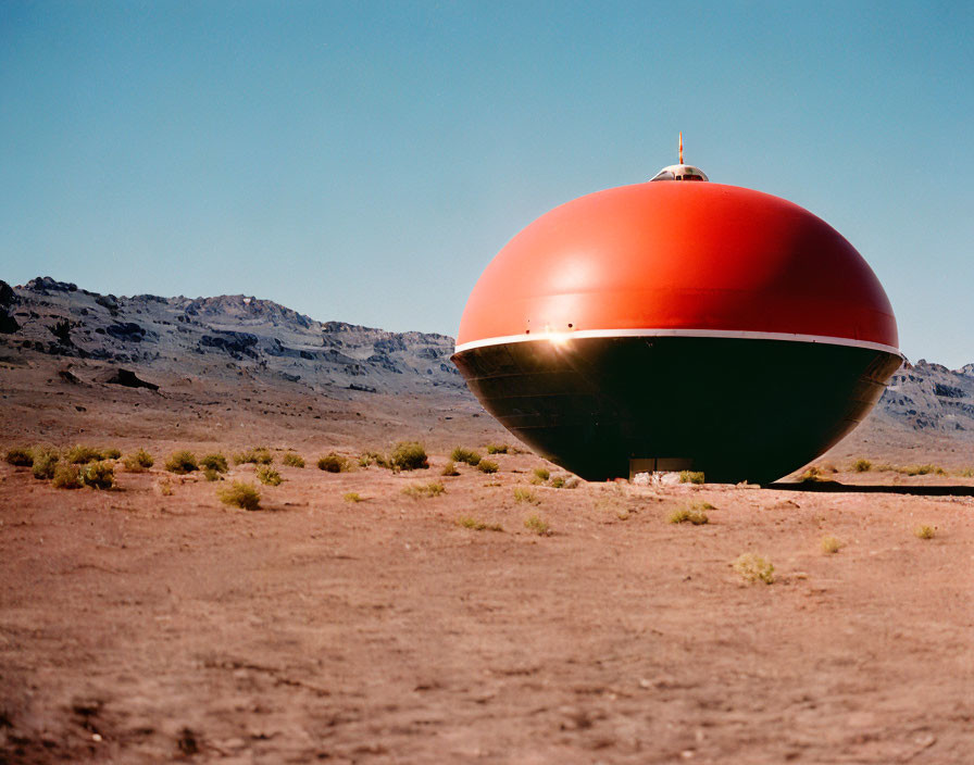 Red and Green Spherical Structure in Barren Desert Landscape