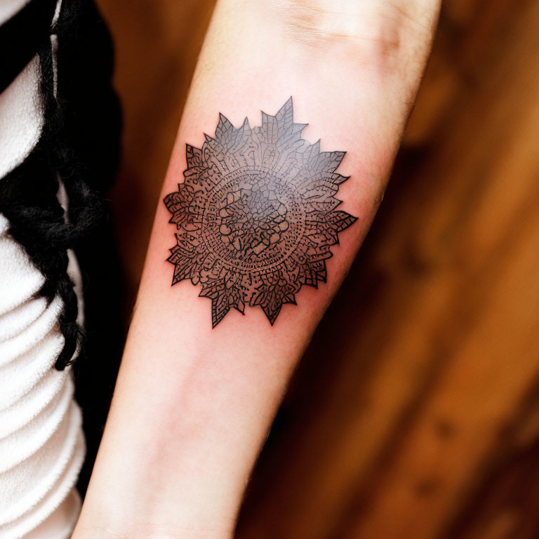 Detailed Black Mandala Tattoo on Inner Forearm with Intricate Floral Motifs