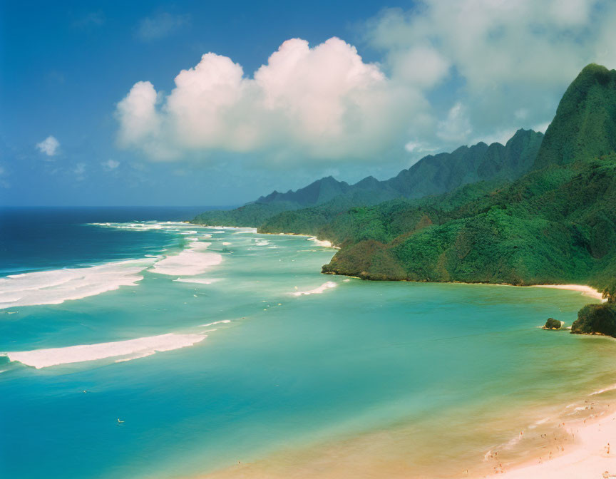 Serene beach with lush mountains and blue skies