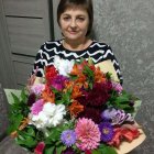 Pensive woman in zigzag sweater amidst lush flowers and birds