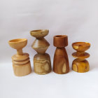 Assorted wooden objects in various shapes and shades on plain background