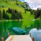 Sunset landscape with hilltop castle, reflective lake, boats, and wooden jetty