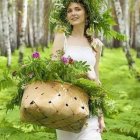 Illustrated woman in floral headdress and white dress with patterned purse in whimsical forest