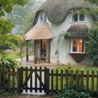 Thatched Roof Wooden Cottage with Blooming Flowers