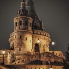 Enchanted castle overlooking illuminated village at night