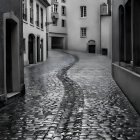 Historic European cobblestone street with old buildings in foggy atmosphere