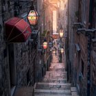 Historic cobblestone alley with stone buildings and lantern light at twilight