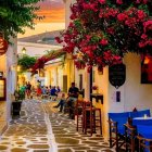 Charming cobblestone street with white houses and blooming roses at twilight