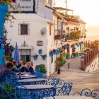 Charming cobblestone street with floral houses at sunset