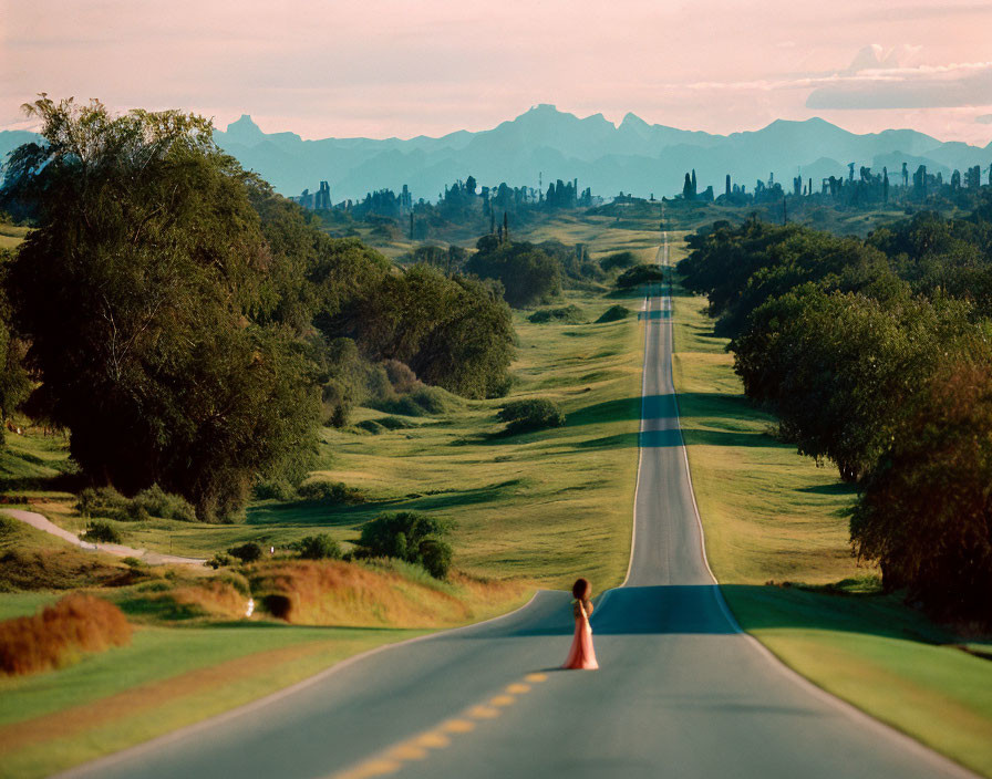 Person in Red Dress on Winding Road Amid Greenery