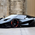 Black Sports Car with Red Accents in Industrial Setting